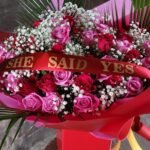 mixed roses 50, with banner , saying "she said yes"